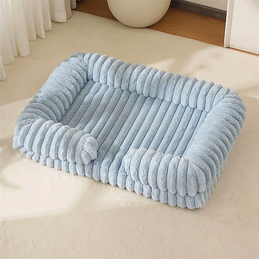 OrthoCanine orthopedic memory foam dog bed in Blue on a soft living room carpet